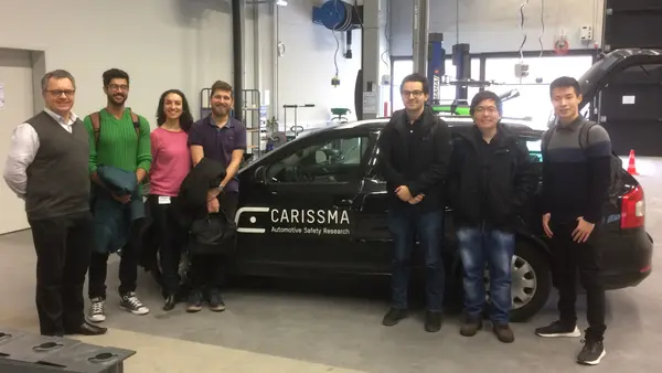 The picture show professor Zimmer and his research team in front of a test car at CARISSMA test and research center