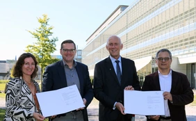 Photo of Anne-Sophie Kopytynski, Christian Müller (Chancellor THI), Prof Walter Schober (President THI) and Prof Alessandro Zimmer.